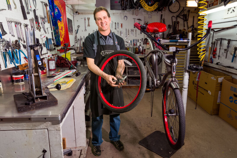 Bike shop owner working on fixing a bike